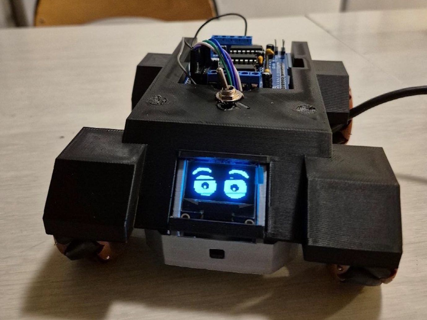 Front view of the robot showing OLED eyes